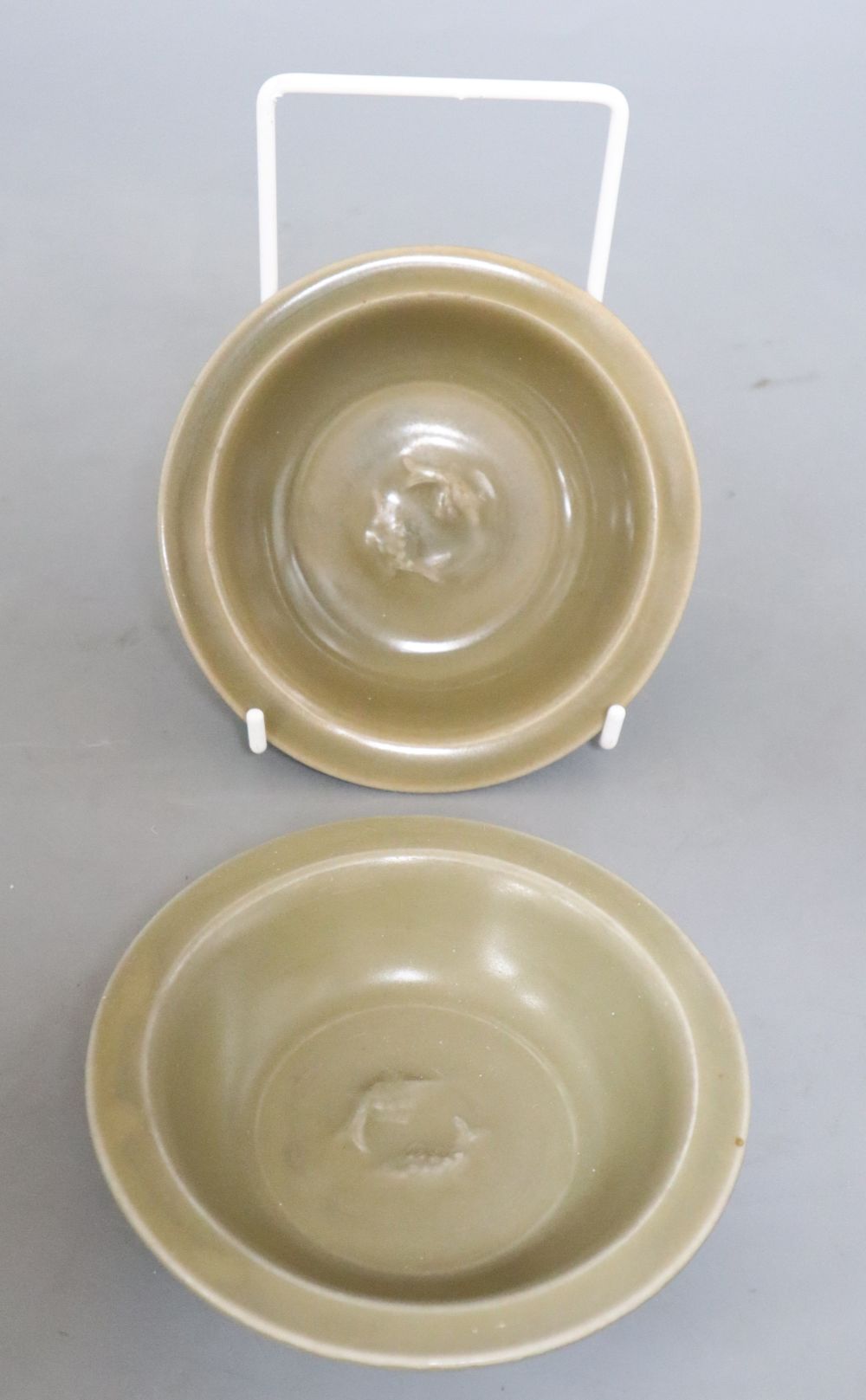 A pair of Chinese celadon twin fish small dishes, diameter 12cm, with associated certificates